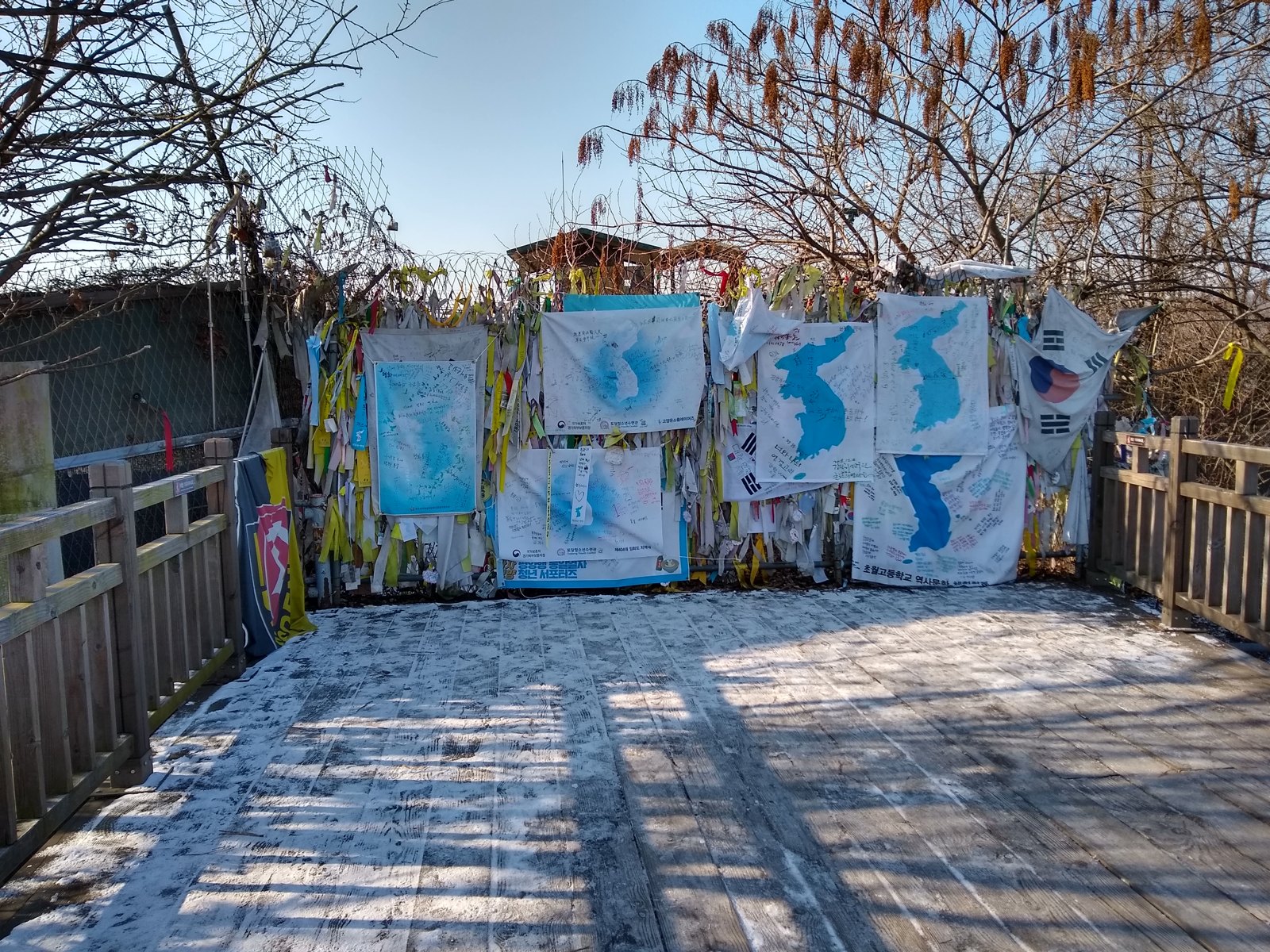 The closed end of the Freedom Bridge at Imjingak, its fence covered with ribbons and flags left by visitors