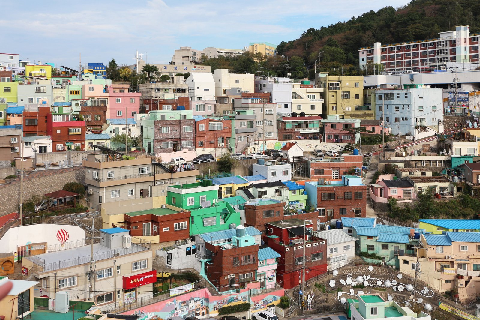 Pastel-colored terraced houses stacked up the hillside of Gamcheon Culture Village, Busan
