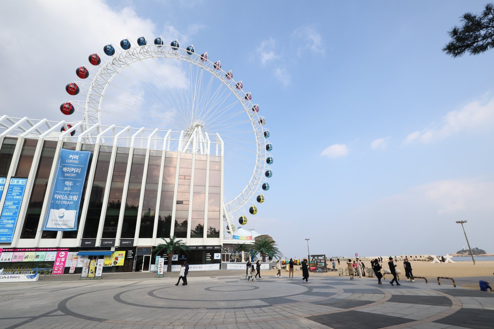 The big wheel and promenade at Sokcho Beach, Gangwon, on a clear day